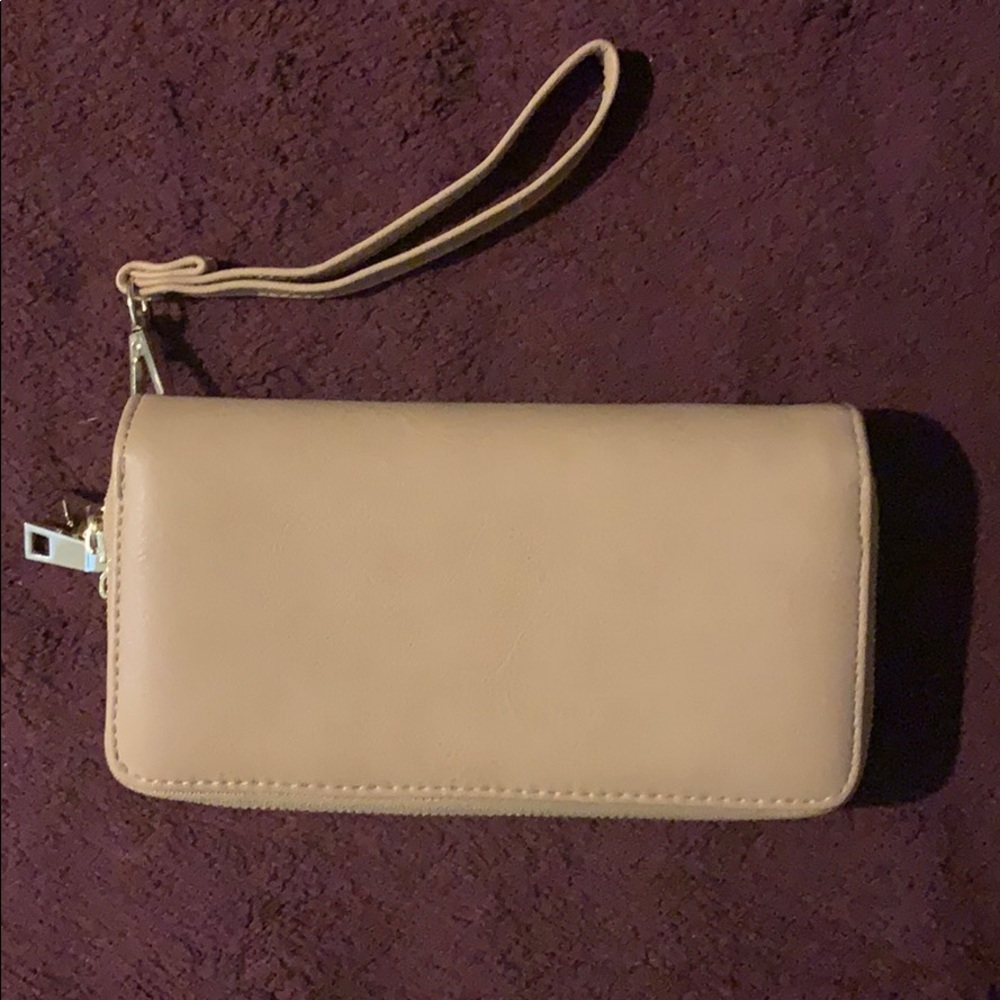 Tan leather clutch with gold zipper accents.